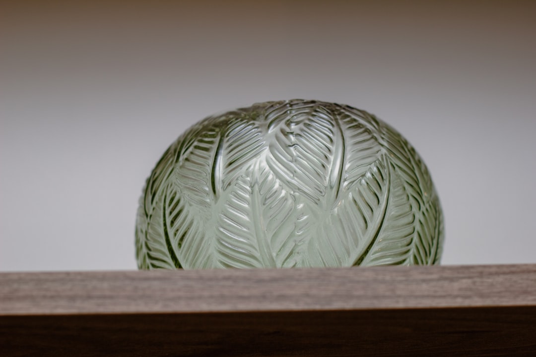 about-01 a-green-vase-sitting-on-top-of-a-wooden-shelf-t7tutarac68